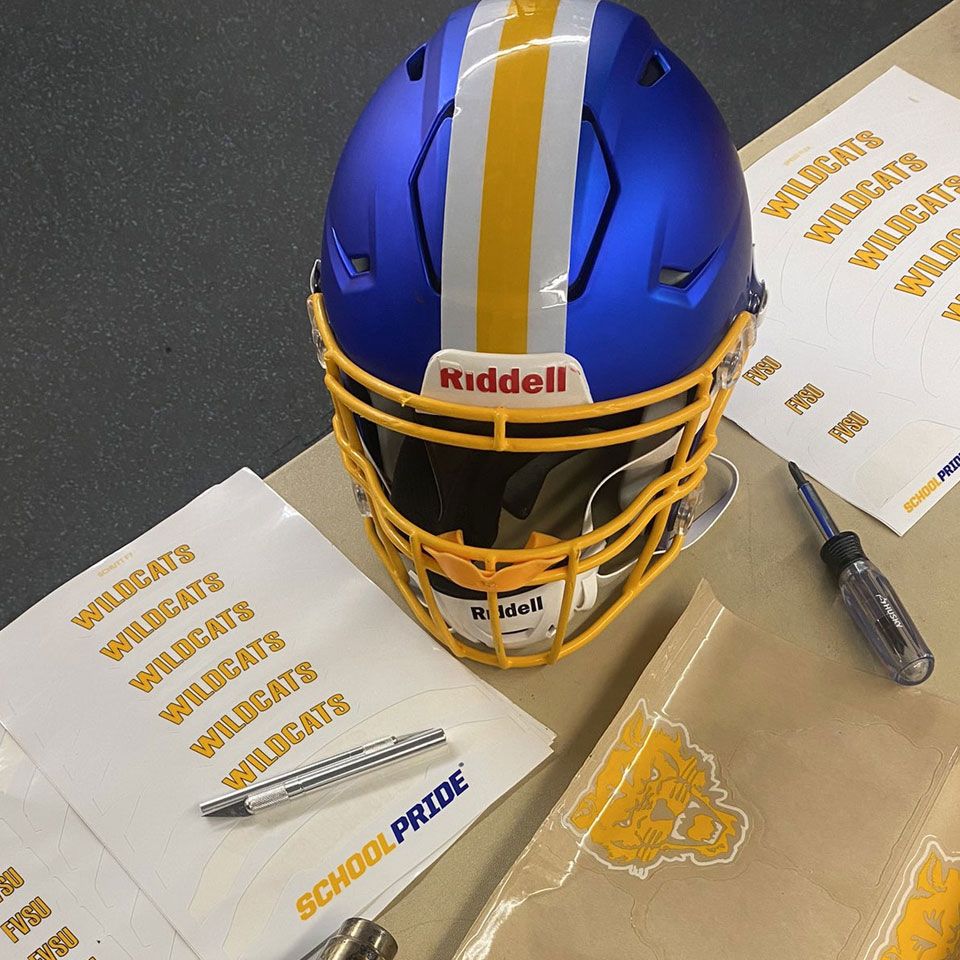 wildcats football decals being applied