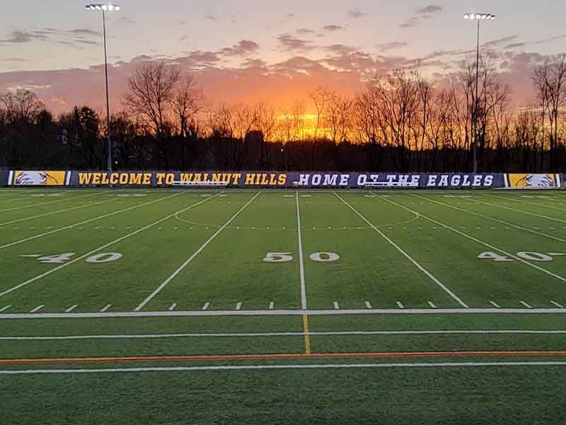 walnut hills high school mesh fence banner at sunset