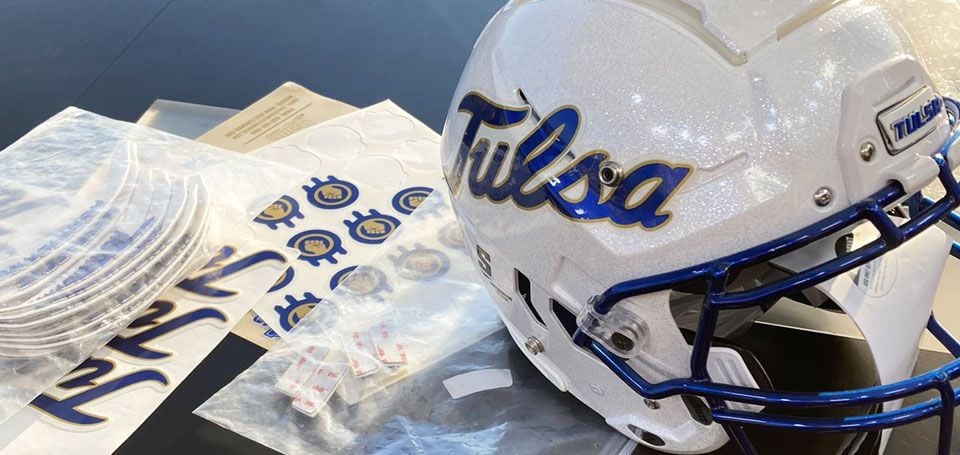 decals being applied to tulsa helmet